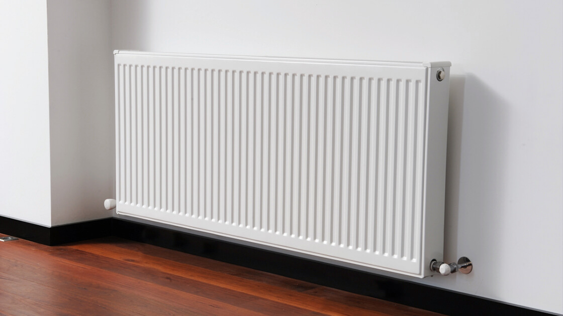 A hydronic radiator adding warmth to a stylish living room